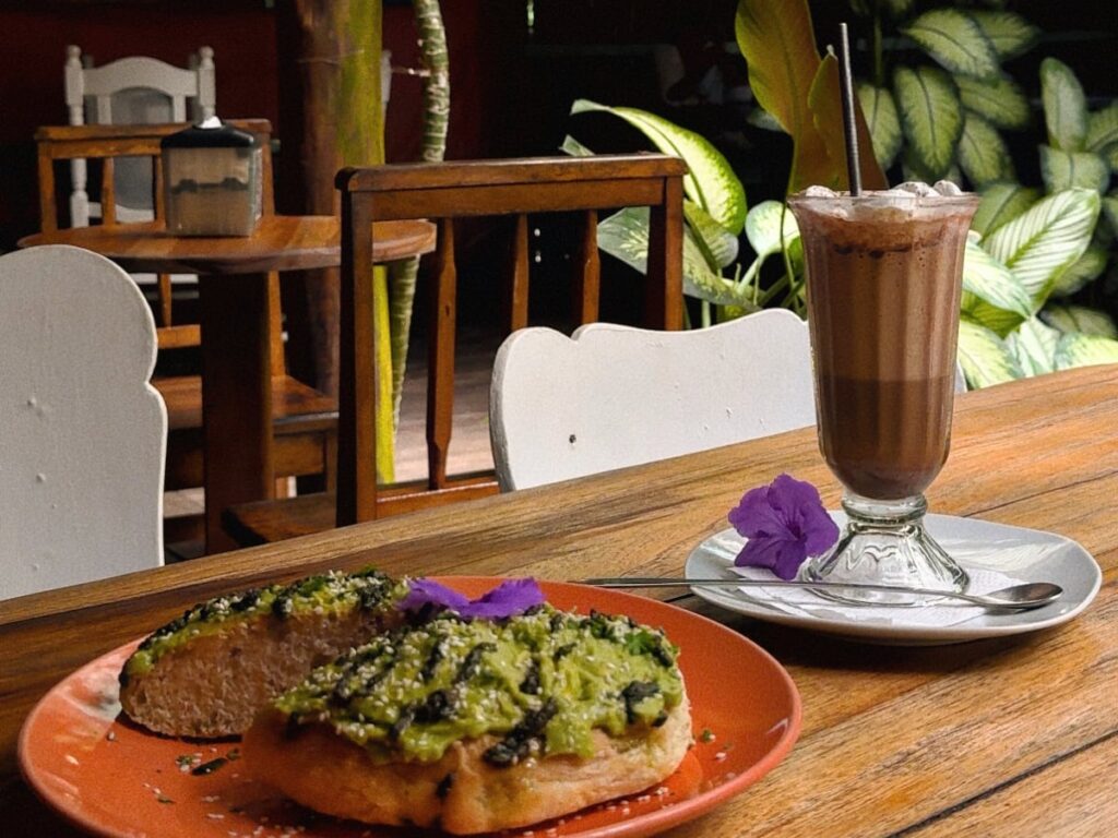 fresh avocado toast and cold cacao drink at gypsea cafe in playa chiquita. one of the best hidden gems in puerto viejo