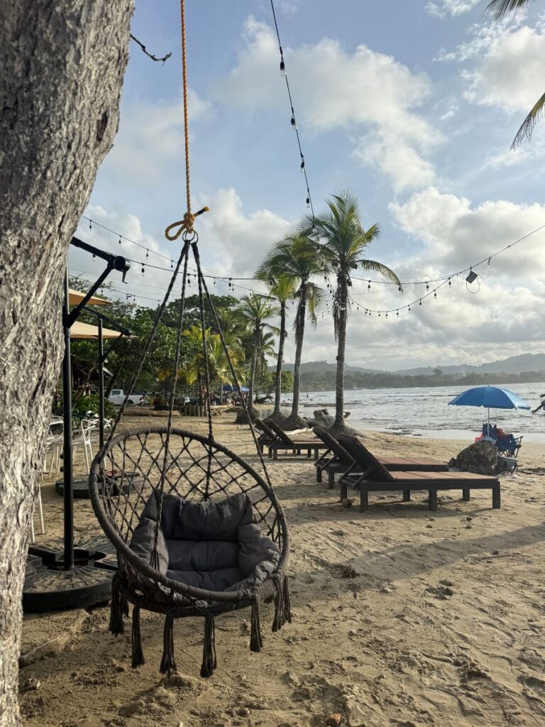 people on the beach watching the sunset on chino beach in puerto viejo